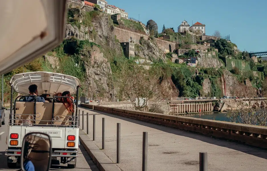 Tuk Tuk driving along the Douro riverside near Porto’s cliffs
