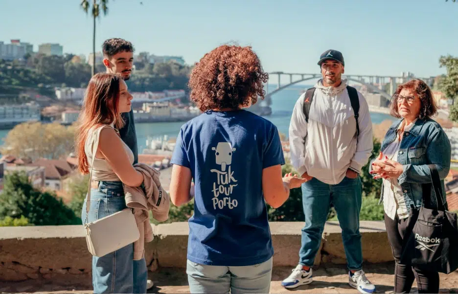 Tour guide explaining Porto’s history to visitors during a Tuk Tuk stop