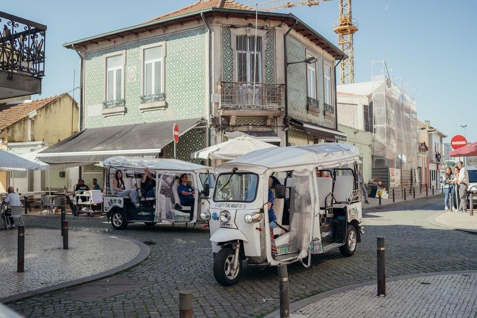 Tuk Tuk tours driving through a traditional street in Porto, Portugal