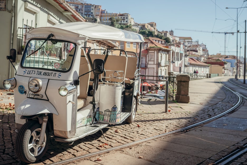 Electric Tuk Tuk parked on a traditional street in Porto, Portugal