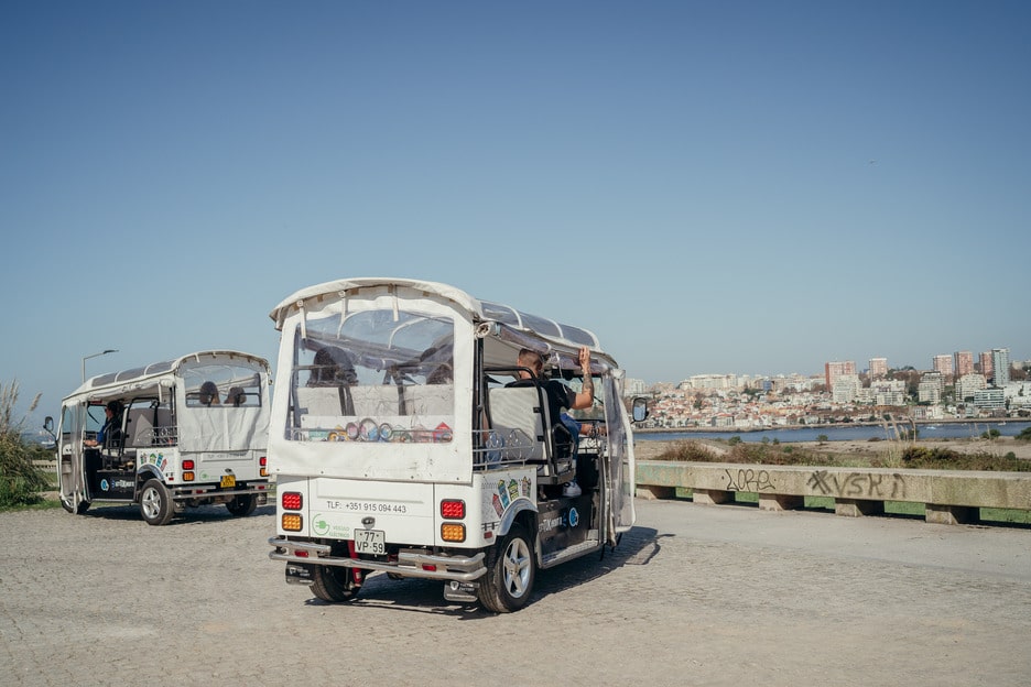 Two Tuk Tuks parked with panoramic city view in Porto, Portugal