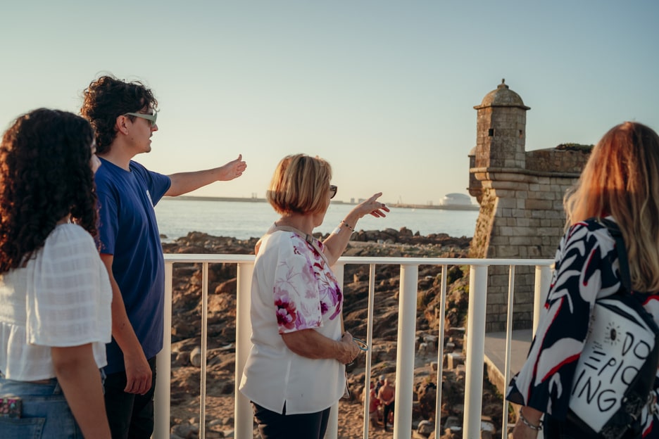 Tour guide showing historical coastal fortress to visitors in Porto, Portuga