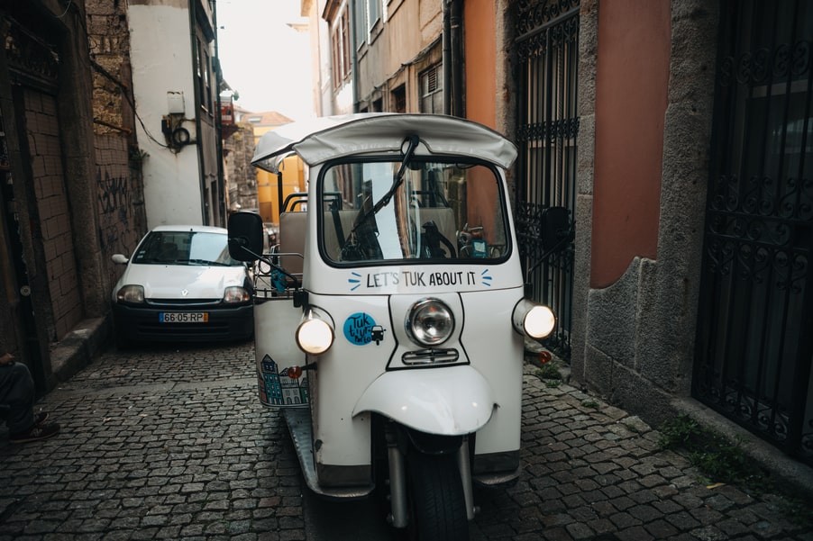 TukTuk navigating narrow streets of Porto – Monastery and Cellars Tour