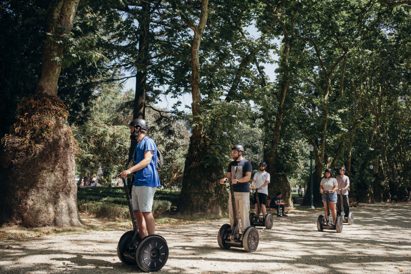 Segway group riding through a green park in Porto